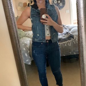 Distressed sleeveless jean jacket with black hood